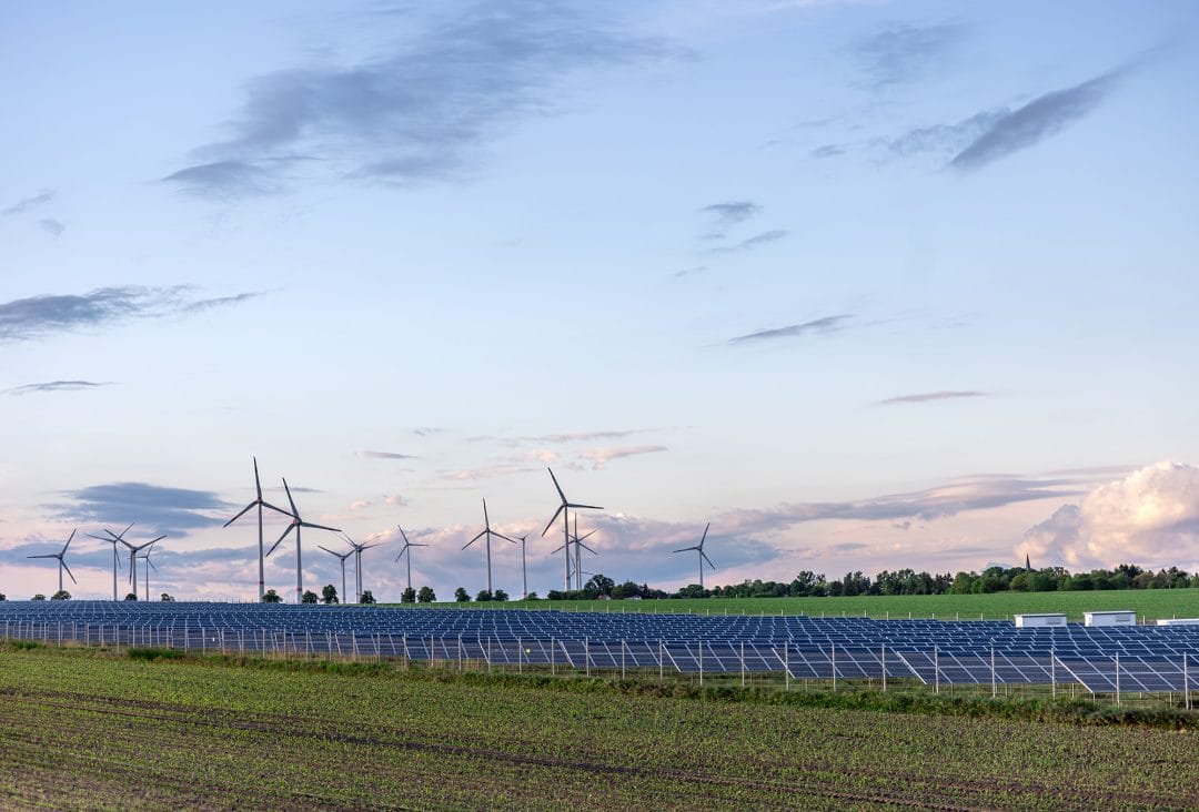 Ananda-Jua-solar-panels-field-wind-turbines-horizon-renewable-green-energy Freight trucks at a charging station Decade Energy